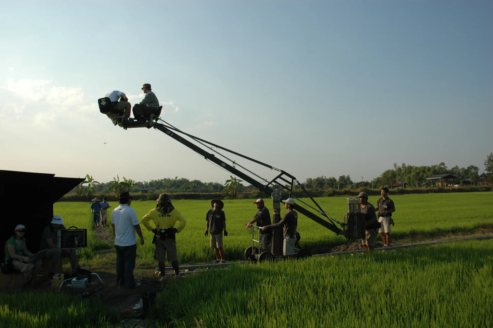 Mediawok crew filming with a camera crane in a Thai rice field